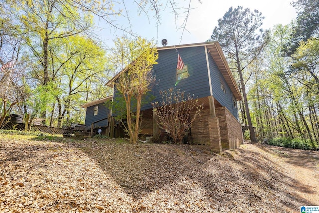 view of property exterior featuring brick siding