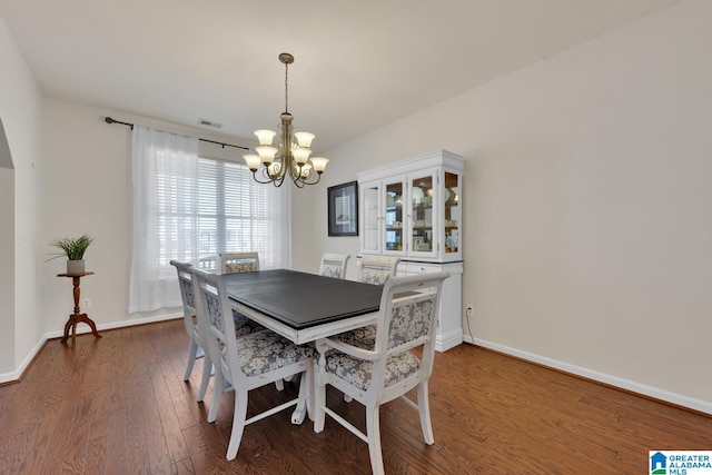 dining room featuring a chandelier and dark hardwood / wood-style flooring