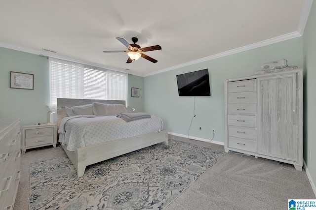 carpeted bedroom with crown molding and ceiling fan