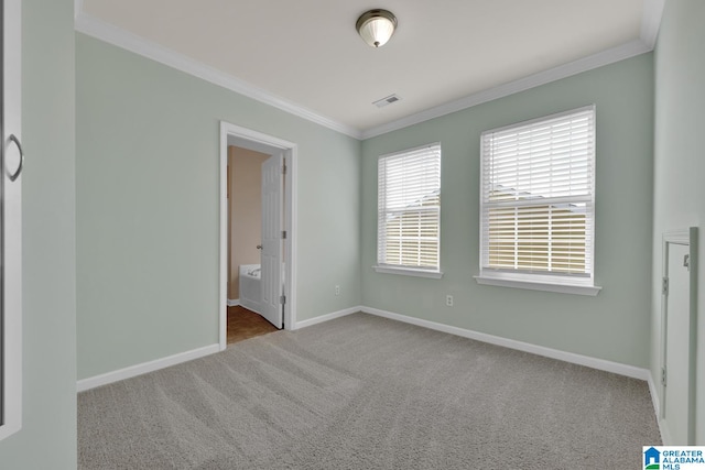 unfurnished bedroom with ensuite bathroom, light carpet, and crown molding