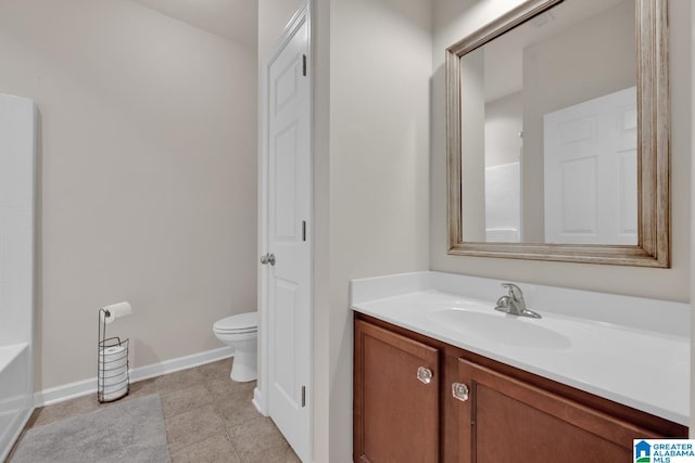 bathroom featuring vanity, toilet, and tile patterned floors