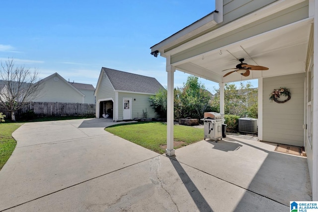 view of patio / terrace featuring ceiling fan, cooling unit, and an outdoor structure