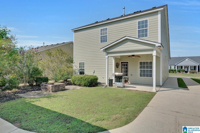 back of house with a patio area, a lawn, and ceiling fan