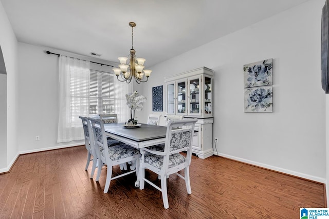 dining area with a chandelier and hardwood / wood-style flooring