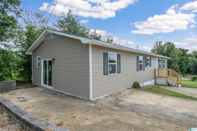 view of side of home featuring a patio area