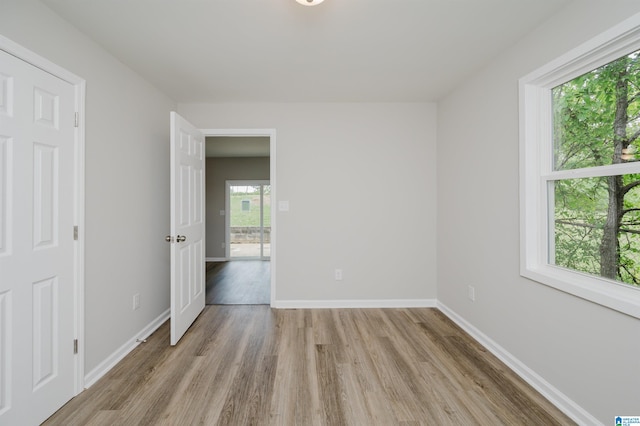 unfurnished room with light hardwood / wood-style flooring