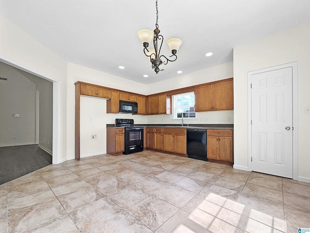 kitchen featuring black appliances, sink, pendant lighting, and a notable chandelier