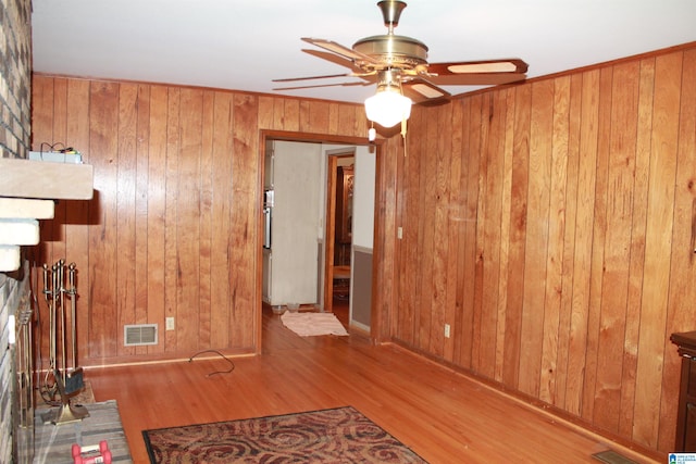 interior space featuring wood walls and light hardwood / wood-style flooring