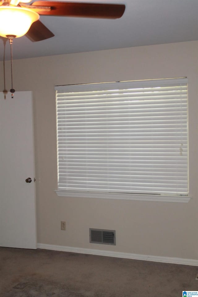 empty room with ceiling fan and carpet