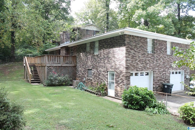 view of property exterior featuring a garage, a wooden deck, and a lawn