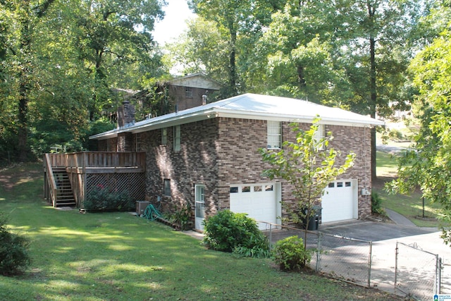 view of home's exterior with a wooden deck, a lawn, and a garage