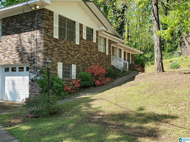 1421 Hickory Ln, Birmingham, AL 35235 - view of property exterior with concrete driveway, brick siding, and an attached garage