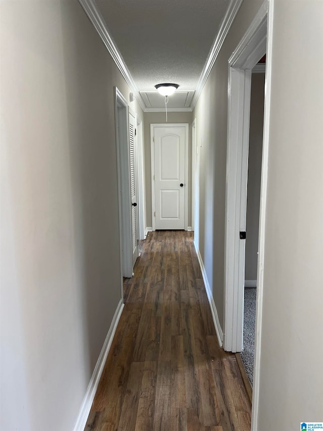 corridor featuring a textured ceiling, ornamental molding, and dark hardwood / wood-style flooring