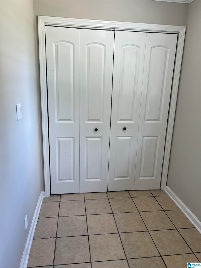 unfurnished bedroom featuring a closet and light tile patterned floors