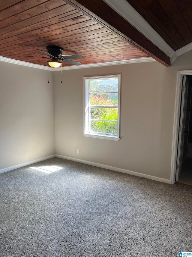 empty room featuring ornamental molding, ceiling fan, wooden ceiling, and carpet flooring