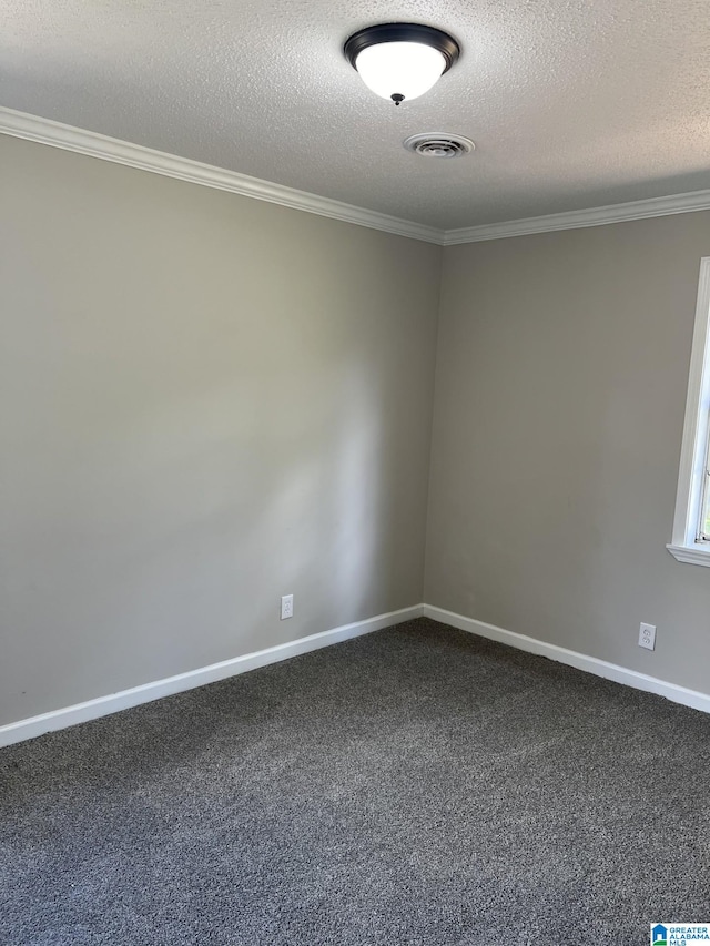 spare room featuring ornamental molding, a textured ceiling, and carpet flooring