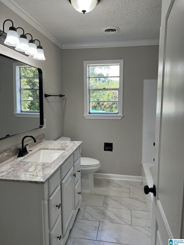 bathroom with a healthy amount of sunlight, crown molding, vanity, and toilet