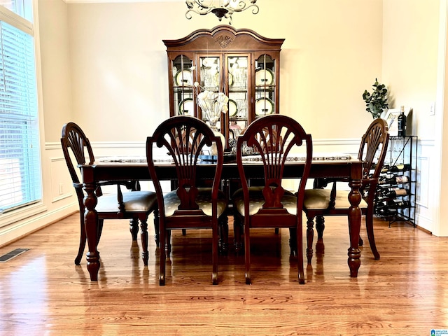 dining space with a notable chandelier and light wood-type flooring