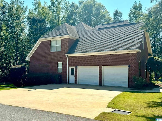 view of home's exterior with a yard and a garage