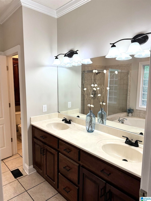 full bathroom featuring vanity, toilet, plus walk in shower, crown molding, and tile patterned flooring