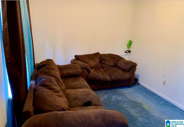 living room with dark colored carpet