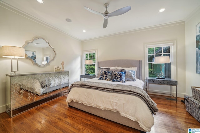 bedroom with crown molding, hardwood / wood-style floors, and ceiling fan