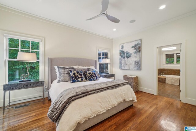 bedroom featuring crown molding, ensuite bath, ceiling fan, and hardwood / wood-style flooring