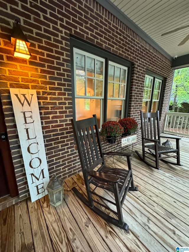 deck with a porch and ceiling fan