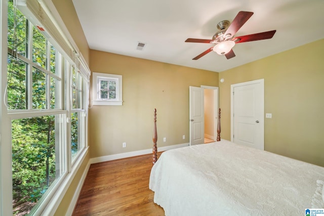 bedroom with ceiling fan and wood-type flooring