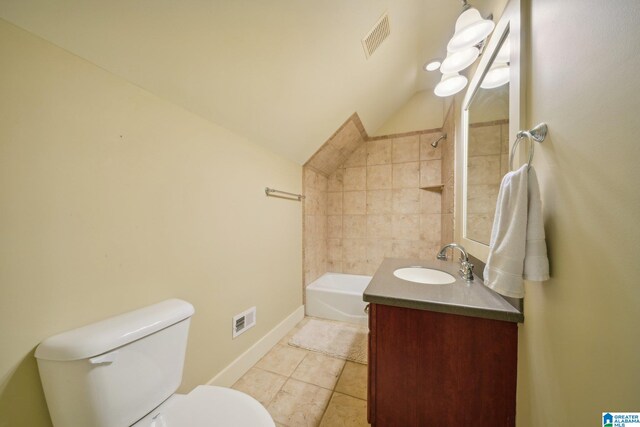 full bathroom with lofted ceiling, tile patterned flooring, tiled shower / bath combo, vanity, and toilet