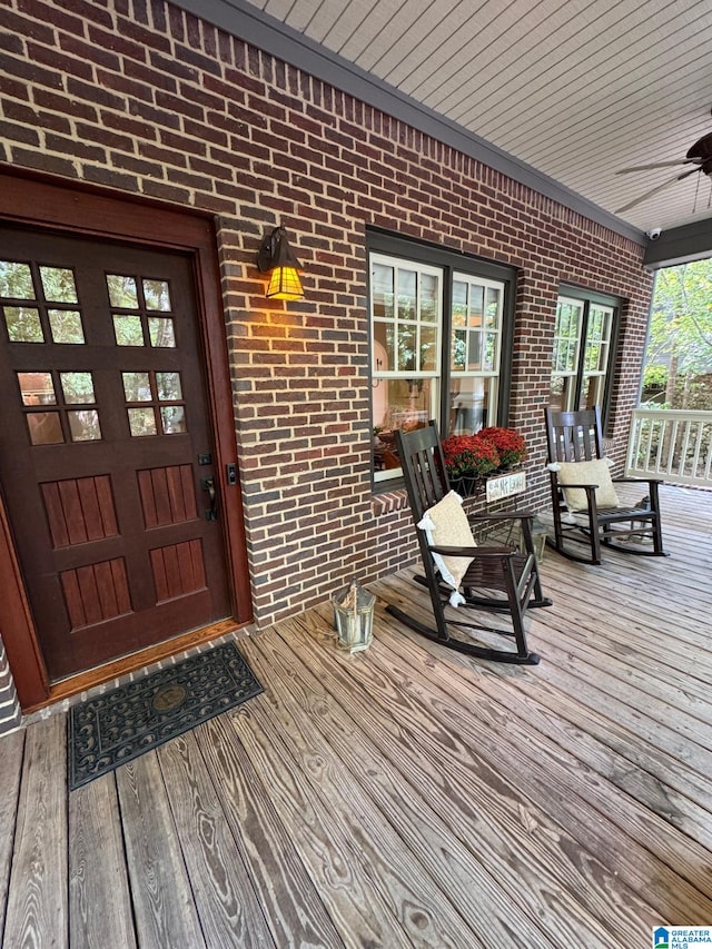 wooden deck with ceiling fan and covered porch