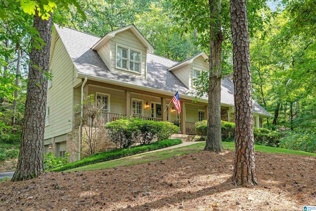 new england style home featuring covered porch