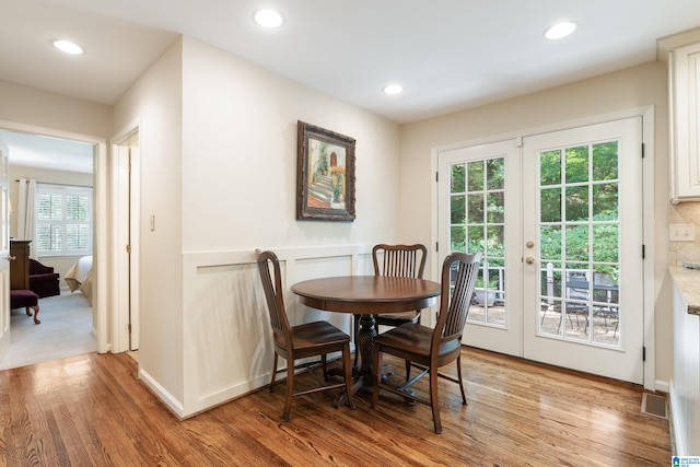 dining space with plenty of natural light and hardwood / wood-style floors