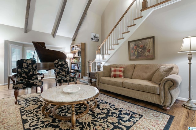 living room with wood-type flooring, beamed ceiling, and high vaulted ceiling