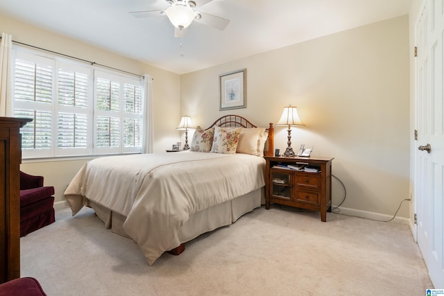 bedroom featuring light carpet and ceiling fan