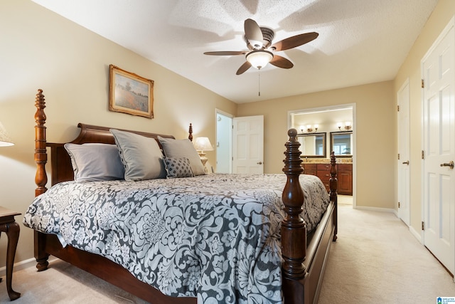 carpeted bedroom featuring connected bathroom, ceiling fan, and a textured ceiling