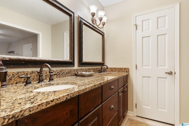 bathroom featuring vanity, a textured ceiling, and tile patterned floors