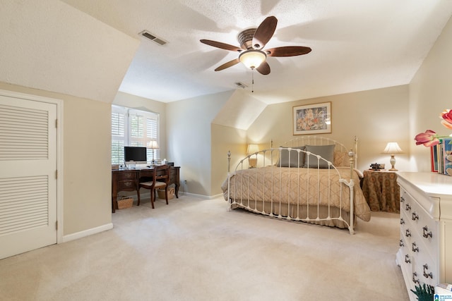 carpeted bedroom with ceiling fan, a textured ceiling, and vaulted ceiling