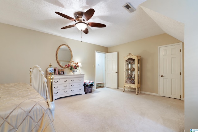 carpeted bedroom featuring lofted ceiling, ceiling fan, and a textured ceiling