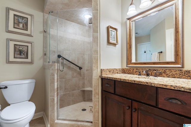 bathroom with vanity, toilet, and an enclosed shower