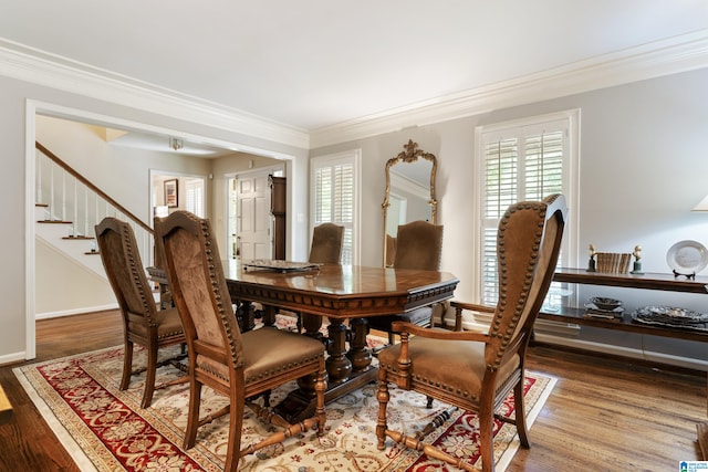 dining room with ornamental molding and hardwood / wood-style floors