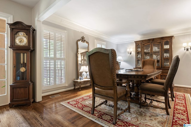 dining room featuring ornamental molding and dark hardwood / wood-style flooring