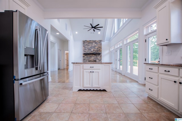 kitchen featuring ornamental molding, light stone countertops, and stainless steel fridge with ice dispenser