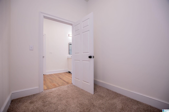 carpeted empty room with baseboards