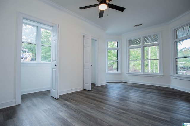 unfurnished bedroom featuring multiple windows, visible vents, and ornamental molding