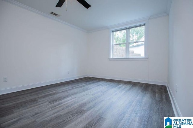 spare room with crown molding, baseboards, visible vents, ceiling fan, and dark wood-style flooring