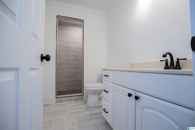 full bath with toilet, vanity, ornamental molding, and a tile shower