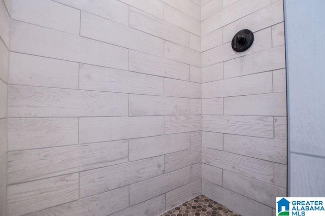 full bath with a tile shower