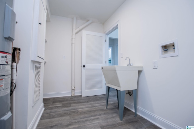 laundry room featuring baseboards, washer hookup, wood finished floors, and laundry area