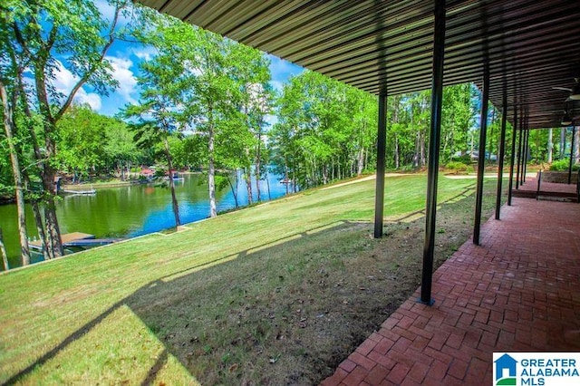 view of yard with a water view and a patio